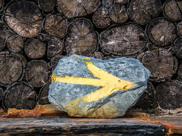 Yellow arrows painted on stone mark the way for pilgrims on every Camino de Santiago route